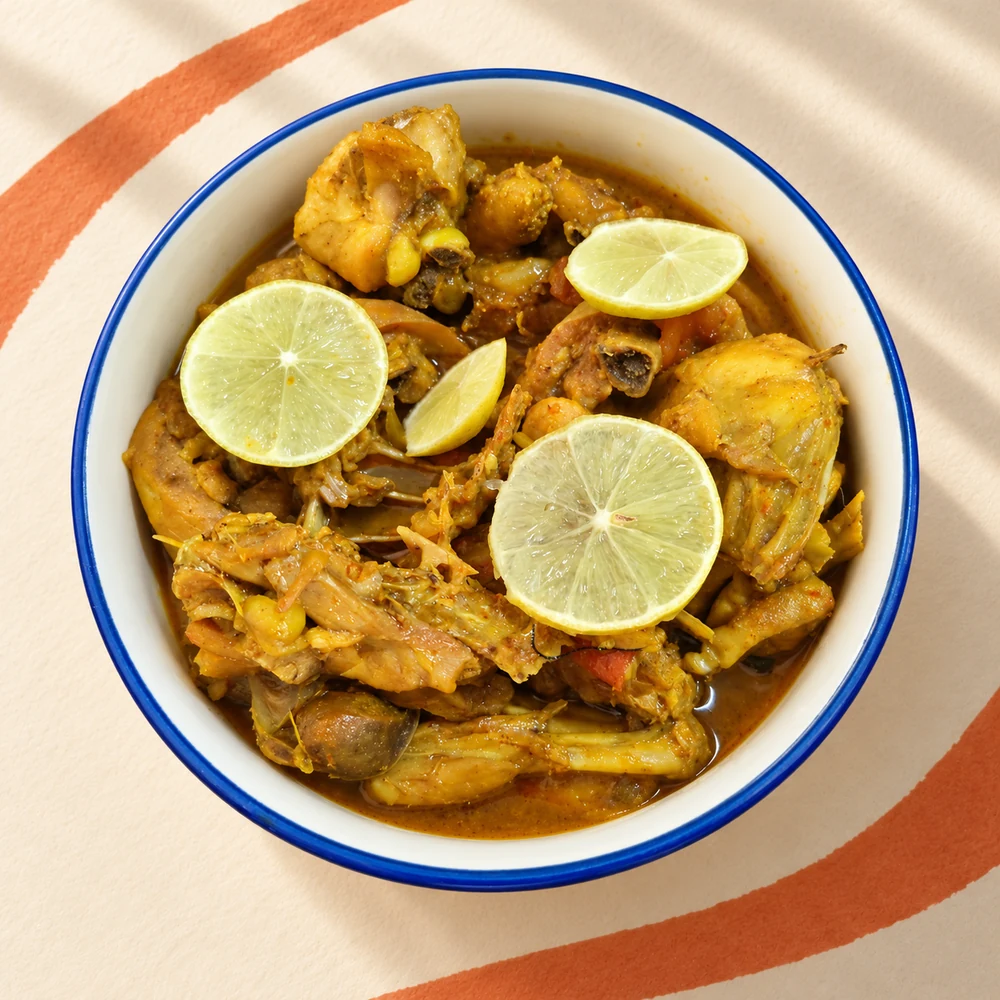Home-style chicken curry in a blue-rimmed bowl